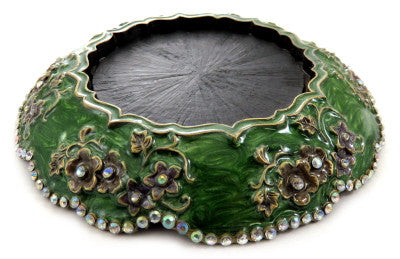 Round candle holder with floral designs along the base and rhinestones lining the bottom ch3